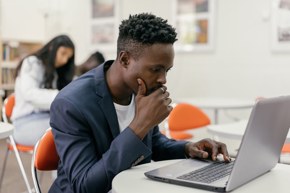 Professional studying for CompTIA Security+ certification exam at computer