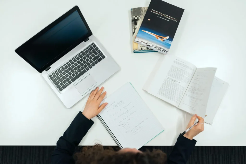 A professional reviewing certification exam scheduling deadlines on a laptop
