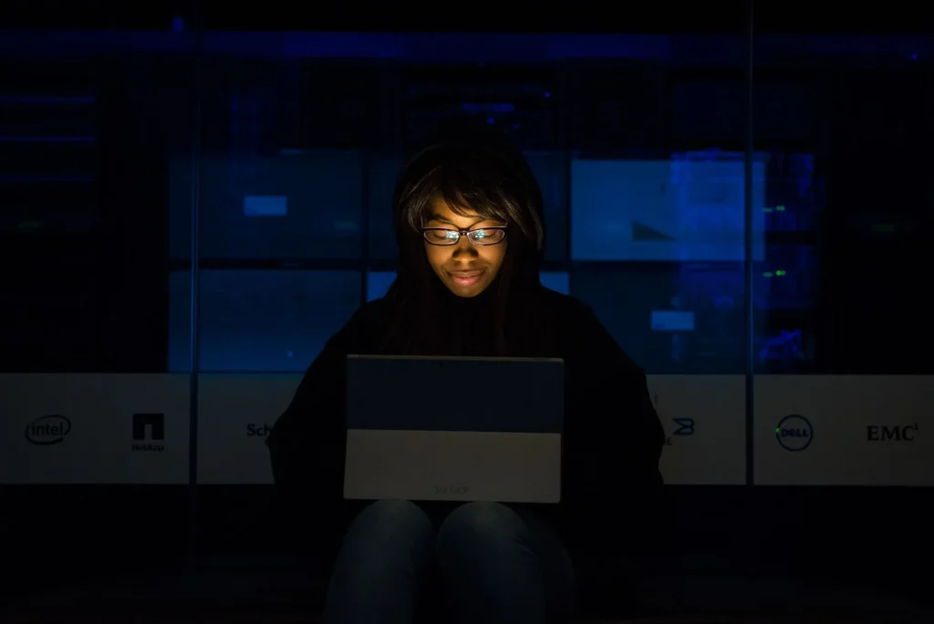 A cybersecurity professional reviewing security protocols on a dual-monitor workstation