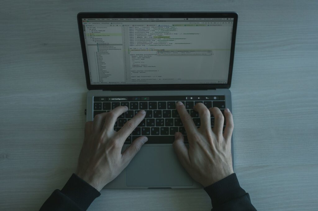 Programmer coding on a laptop representing Claude Sonnet 5 for IT certification study