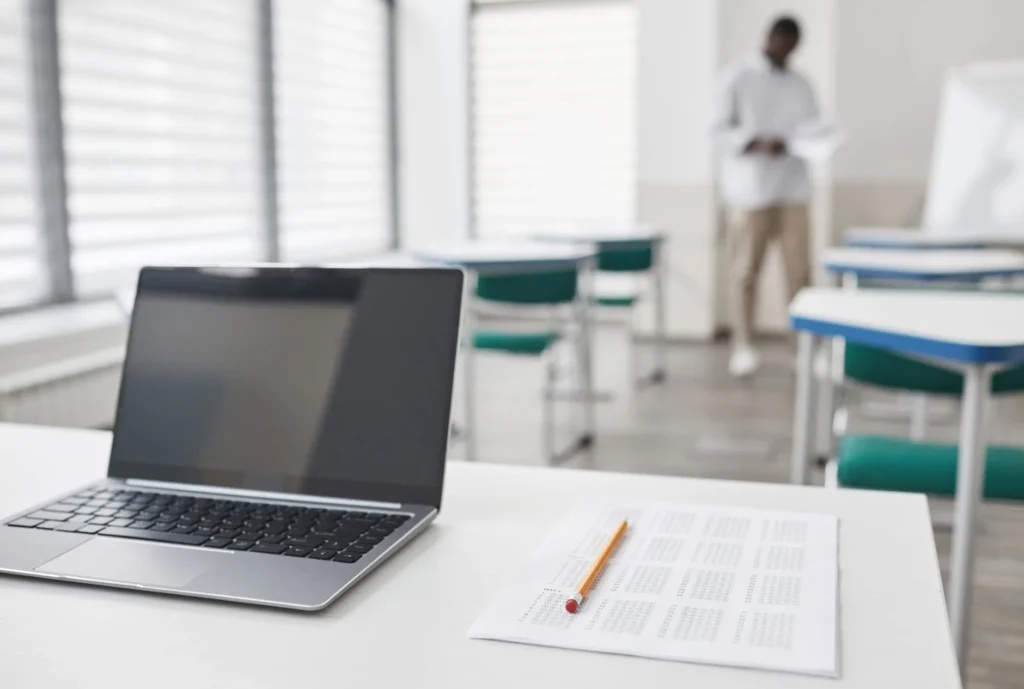 A professional reviewing IT certification study materials on a laptop at a tidy desk