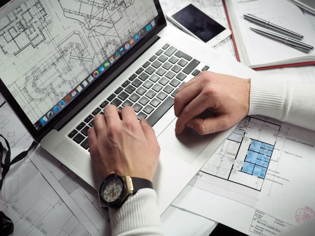 IT professional comparing vendor certification exam paths on a laptop at a study desk
