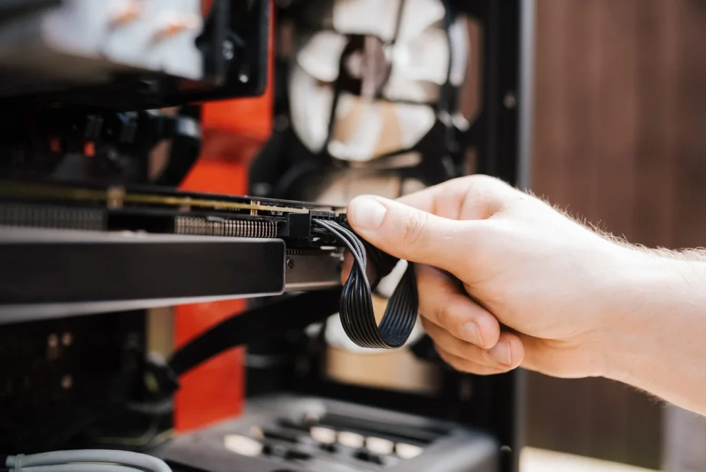 IT support technician diagnosing and installing hardware components at a workstation